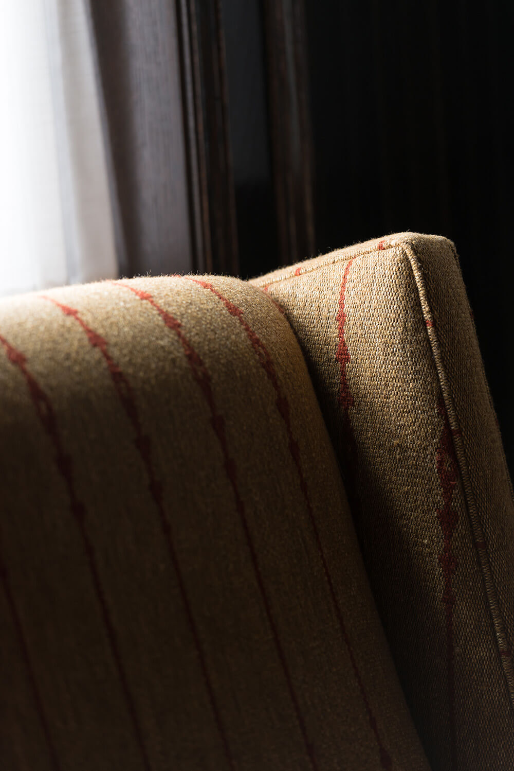 Striped fabric detail on corner of chair.