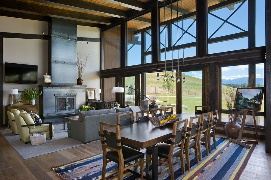 Dining room with custom handwoven rug. View of hilside through floor-to-cieling windows.